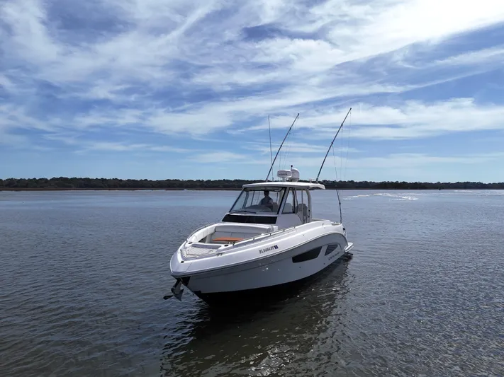  Yacht Photos Pics 2020 Regal 33 SAV boat on calm water under a blue sky.