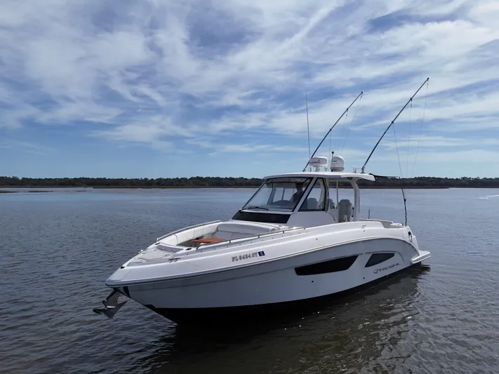  Yacht Photos Pics 2020 Regal 33 SAV boat on calm water under a blue sky.