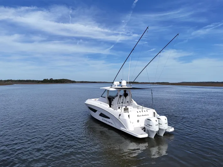  Yacht Photos Pics 2020 Regal 33 SAV boat on calm water under a clear blue sky.