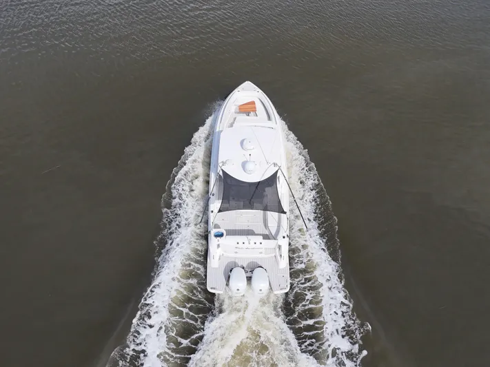  Yacht Photos Pics Aerial view of 2020 Regal 33 SAV boat cruising on water.