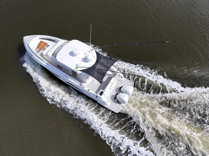  Yacht Photos Pics 2020 Regal 33 SAV boat cruising on water, aerial view.