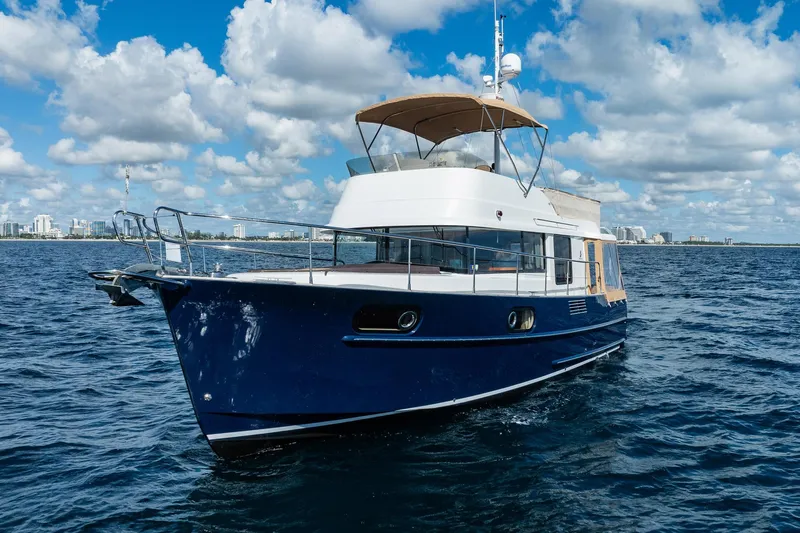Wanderer Yacht Photos Pics 2016 Beneteau Swift Trawler 44 cruising on open water under a partly cloudy sky.