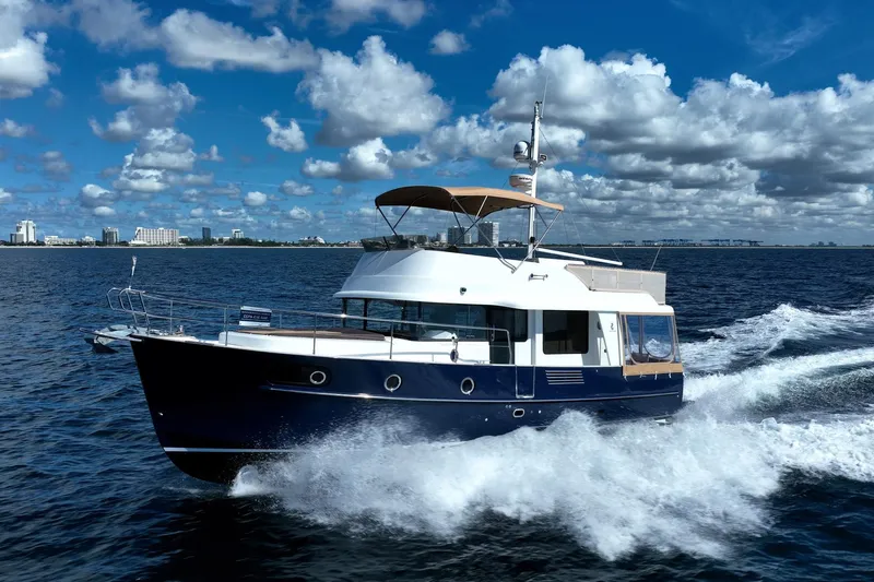 Wanderer Yacht Photos Pics 2016 Beneteau Swift Trawler 44 cruising on open water under a cloudy sky.