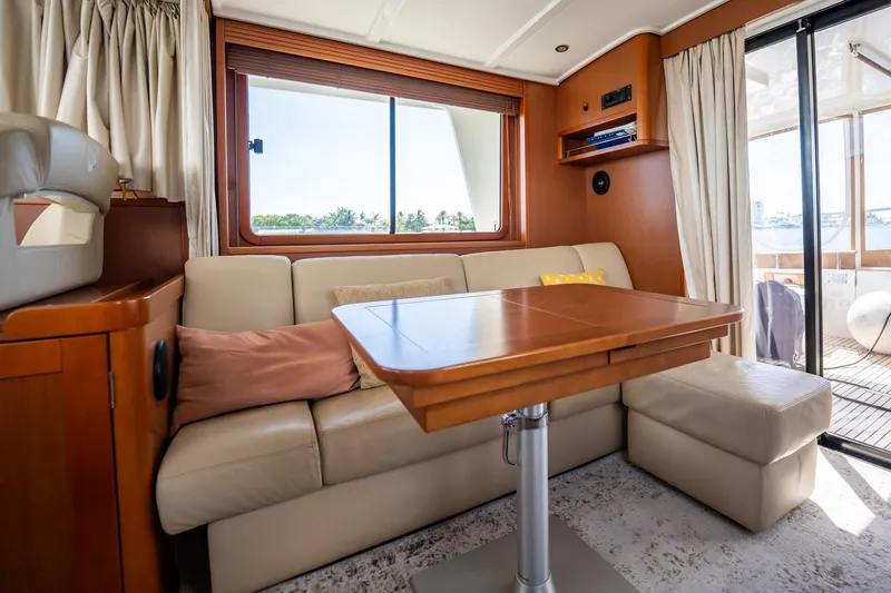 Wanderer Yacht Photos Pics Interior of 2016 Beneteau Swift Trawler 44 with cozy seating and wooden table.