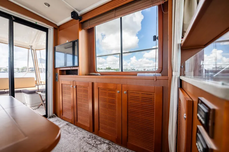 Wanderer Yacht Photos Pics Interior of 2016 Beneteau Swift Trawler 44 with wood cabinetry and large windows.