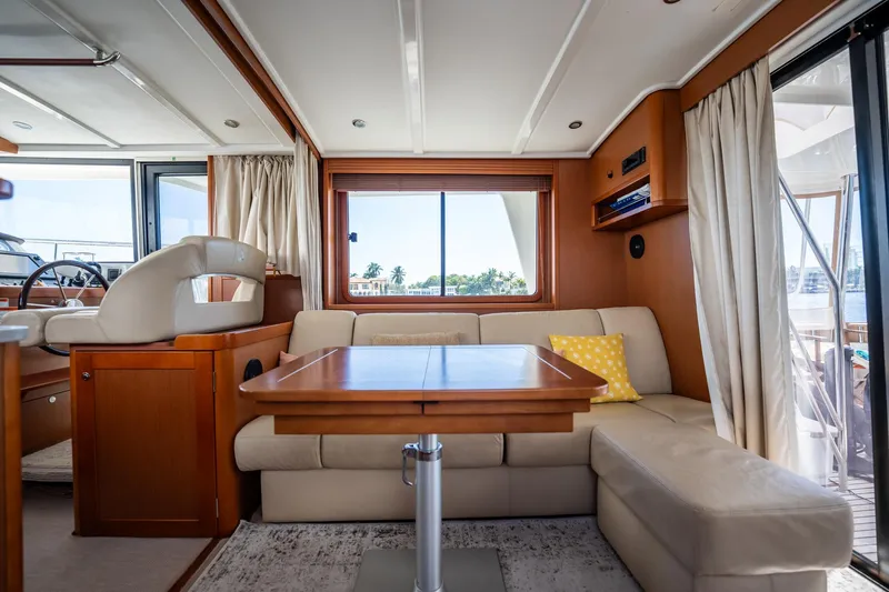 Wanderer Yacht Photos Pics Interior of 2016 Beneteau Swift Trawler 44 with cozy seating and wooden accents.