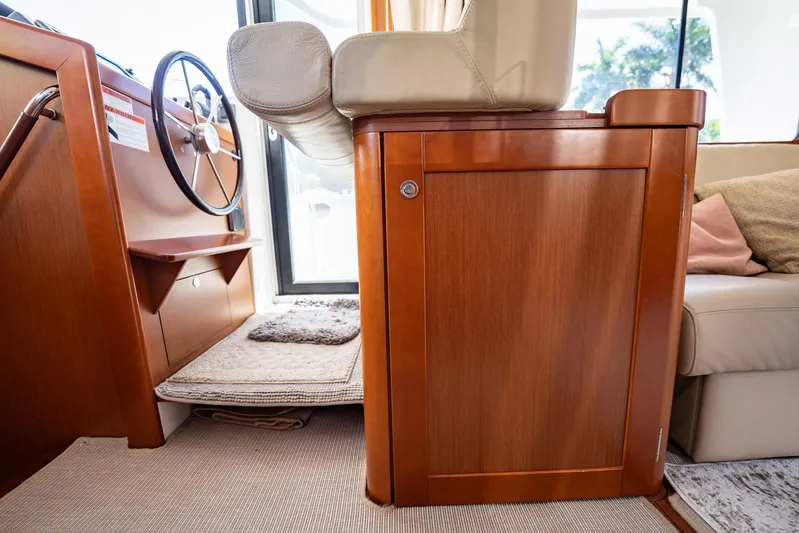 Wanderer Yacht Photos Pics Interior of 2016 Beneteau Swift Trawler 44 with wooden cabinetry and steering wheel.