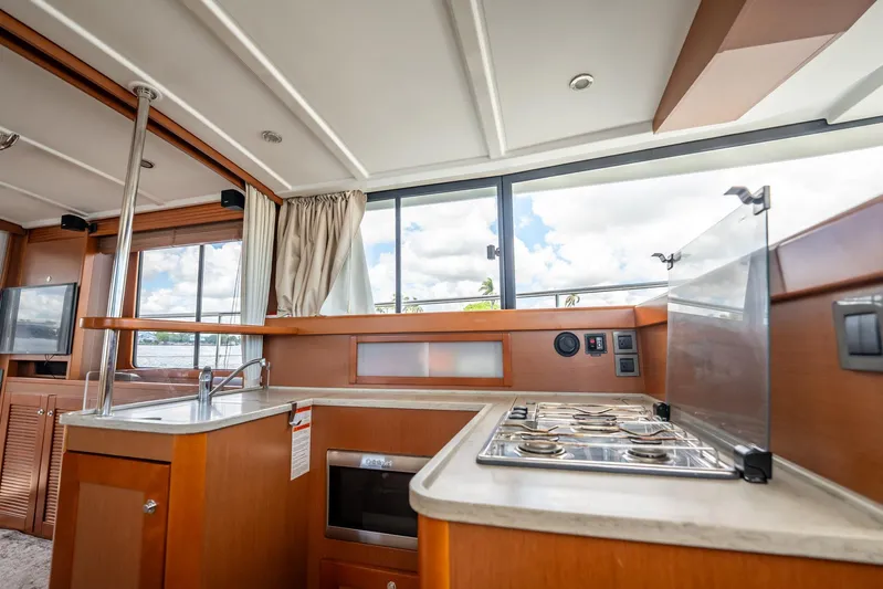 Wanderer Yacht Photos Pics Interior of 2016 Beneteau Swift Trawler 44, featuring modern kitchen with stove and sink.
