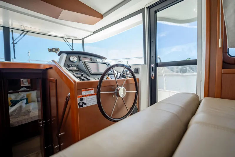 Wanderer Yacht Photos Pics 2016 Beneteau Swift Trawler 44 helm station with modern navigation equipment and comfortable seating.