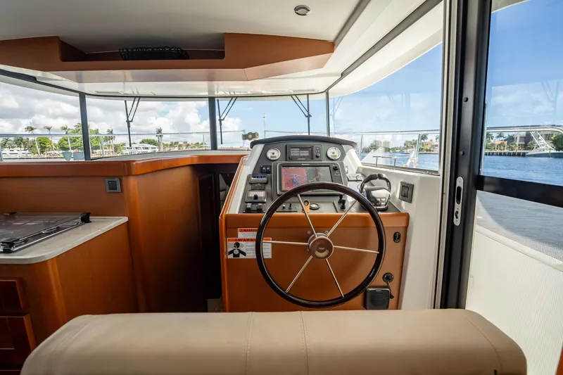 Wanderer Yacht Photos Pics 2016 Beneteau Swift Trawler 44 helm with steering wheel and navigation equipment.