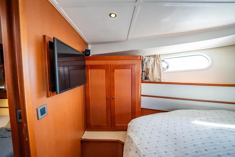 Wanderer Yacht Photos Pics 2016 Beneteau Swift Trawler 44 cabin with wood paneling, TV, and porthole window.