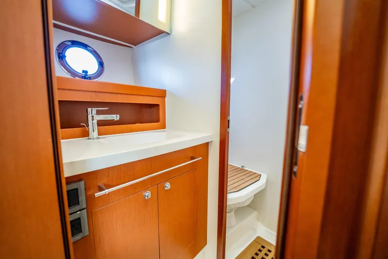 Wanderer Yacht Photos Pics 2016 Beneteau Swift Trawler 44 bathroom with wooden cabinetry and modern fixtures.
