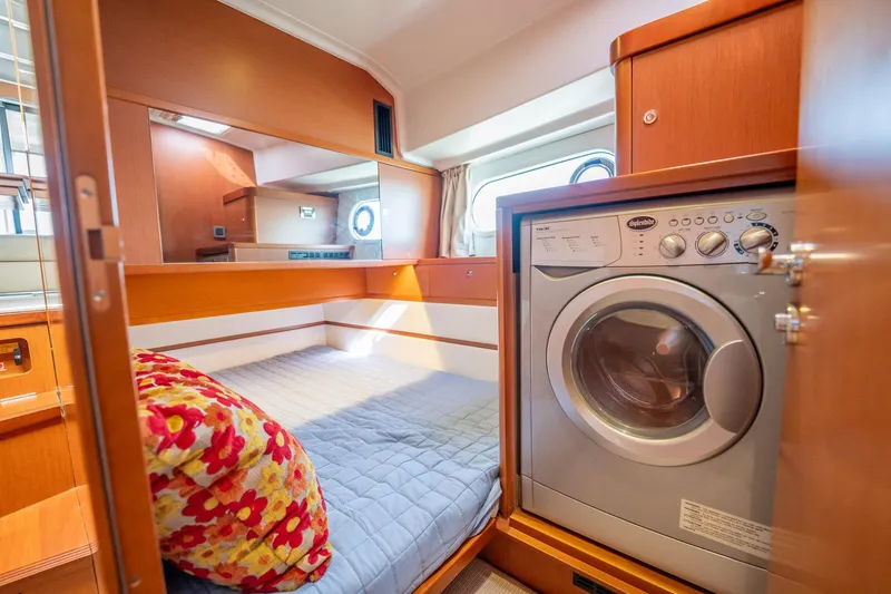 Wanderer Yacht Photos Pics 2016 Beneteau Swift Trawler 44 interior with bed and washing machine.