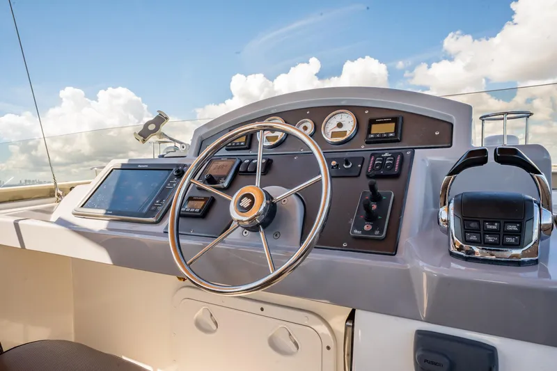 Wanderer Yacht Photos Pics Helm of 2016 Beneteau Swift Trawler 44 with steering wheel and navigation controls.