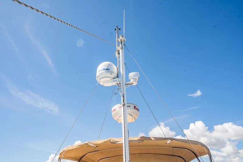 Wanderer Yacht Photos Pics Antenna and radar equipment on 2016 Beneteau Swift Trawler 44 against blue sky.