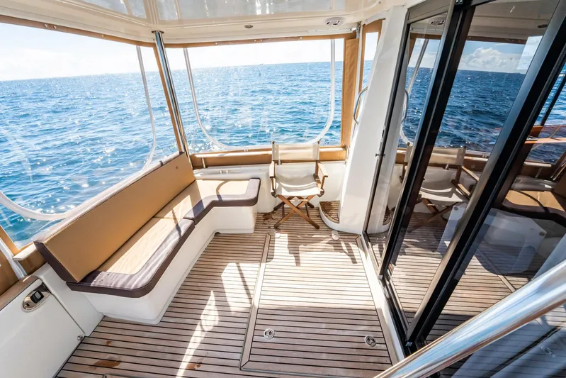 Wanderer Yacht Photos Pics 2016 Beneteau Swift Trawler 44 interior with ocean view, featuring wooden deck and seating.