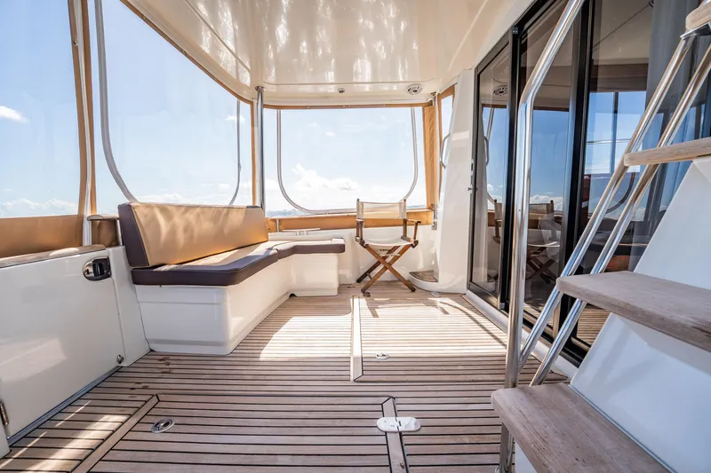Wanderer Yacht Photos Pics 2016 Beneteau Swift Trawler 44 interior with seating, wooden flooring, and ocean view.