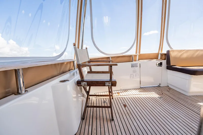 Wanderer Yacht Photos Pics 2016 Beneteau Swift Trawler 44 interior with wooden chair and panoramic windows.