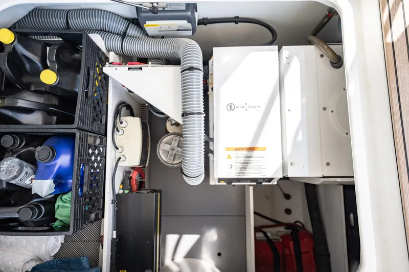 Wanderer Yacht Photos Pics Engine room of 2016 Beneteau Swift Trawler 44 with equipment and storage containers.