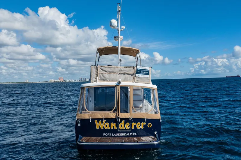 Wanderer Yacht Photos Pics 2016 Beneteau Swift Trawler 44 on open sea, Fort Lauderdale backdrop.
