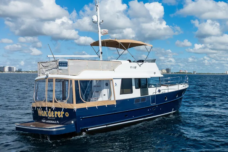 Wanderer Yacht Photos Pics 2016 Beneteau Swift Trawler 44 cruising on open water under a clear blue sky.