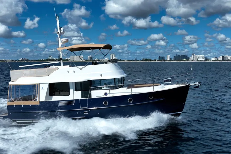 Wanderer Yacht Photos Pics 2016 Beneteau Swift Trawler 44 cruising on open water under a partly cloudy sky.