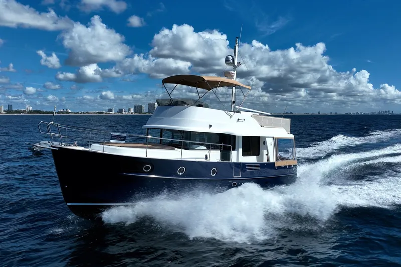 Wanderer Yacht Photos Pics 2016 Beneteau Swift Trawler 44 cruising on open water under a blue sky.