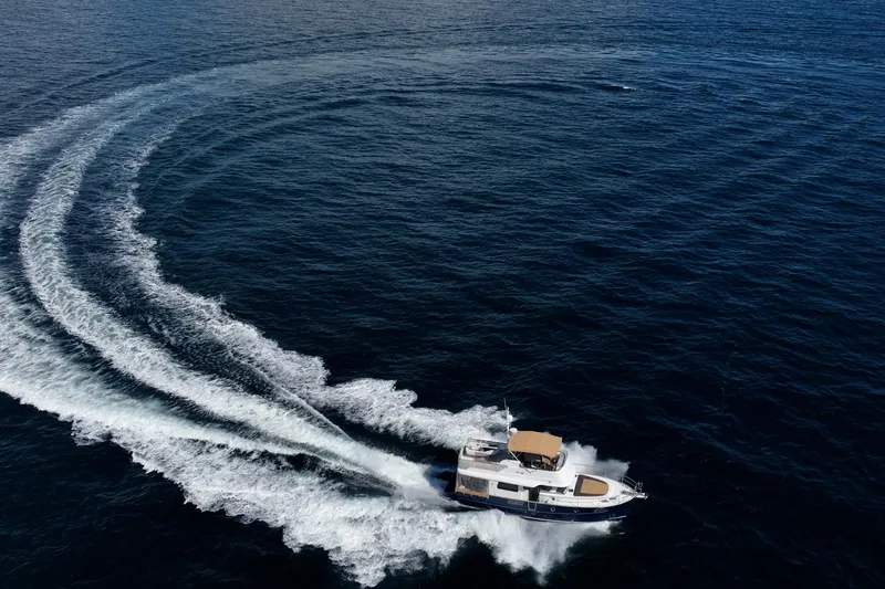 Wanderer Yacht Photos Pics 2016 Beneteau Swift Trawler 44 making a sharp turn on open water.