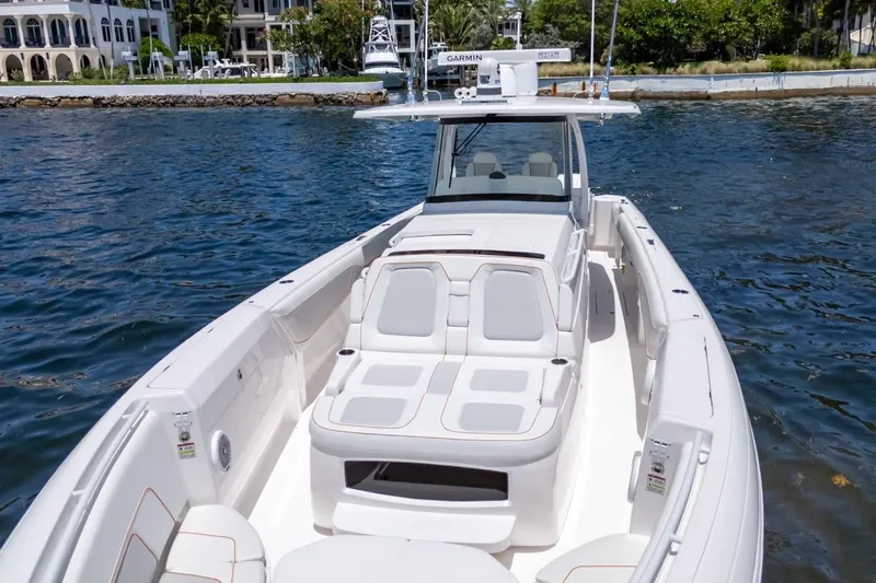  Yacht Photos Pics 2021 Intrepid 407 Panacea boat on water, featuring sleek design and comfortable seating.