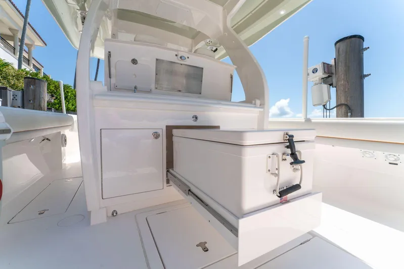  Yacht Photos Pics 2021 Intrepid 407 Panacea boat interior with storage compartments and cooler.