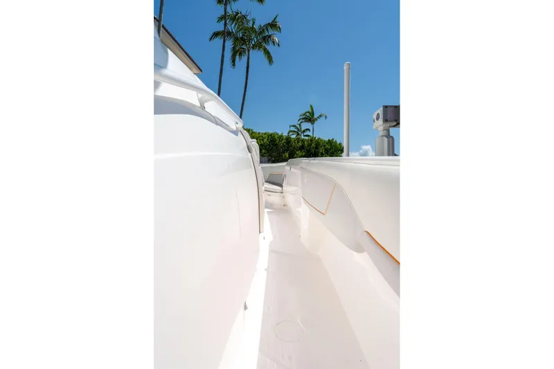  Yacht Photos Pics 2021 Intrepid 407 Panacea boat deck with palm trees and clear blue sky.