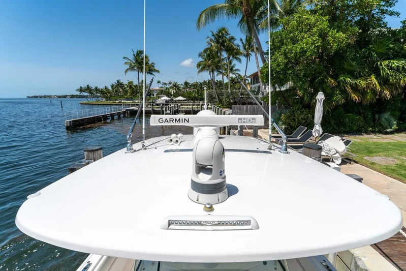  Yacht Photos Pics 2021 Intrepid 407 Panacea boat docked by tropical waterfront with palm trees.