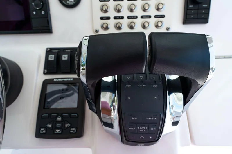  Yacht Photos Pics Control panel of 2021 Intrepid 407 Panacea boat with throttle and navigation controls.