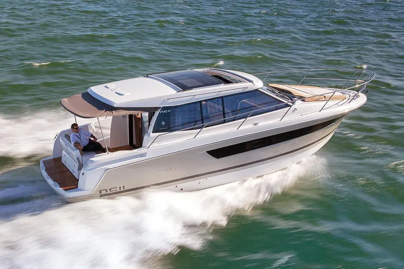  Yacht Photos Pics 2015 Jeanneau NC11 cruising on open water, showcasing sleek design and modern features.