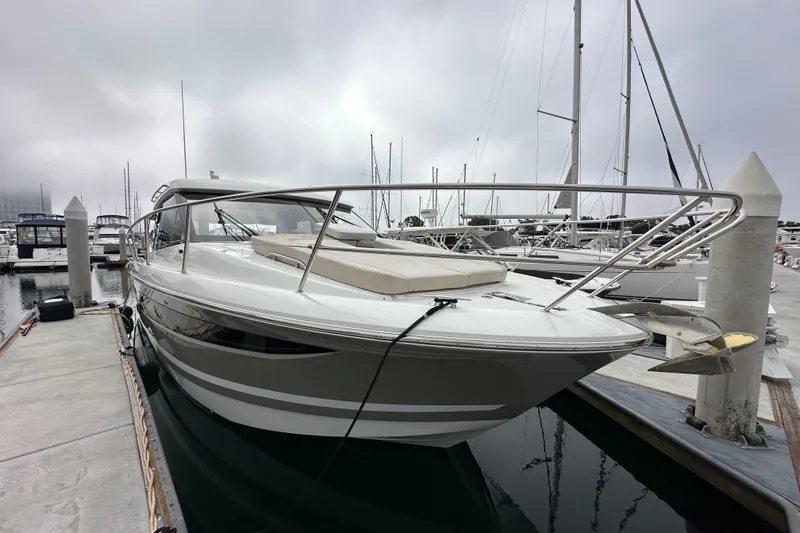  Yacht Photos Pics 2015 Jeanneau NC11 yacht docked at marina, overcast sky, sleek design.