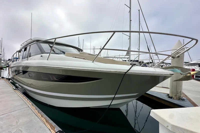  Yacht Photos Pics 2015 Jeanneau NC11 yacht docked at marina, sleek design, overcast sky.