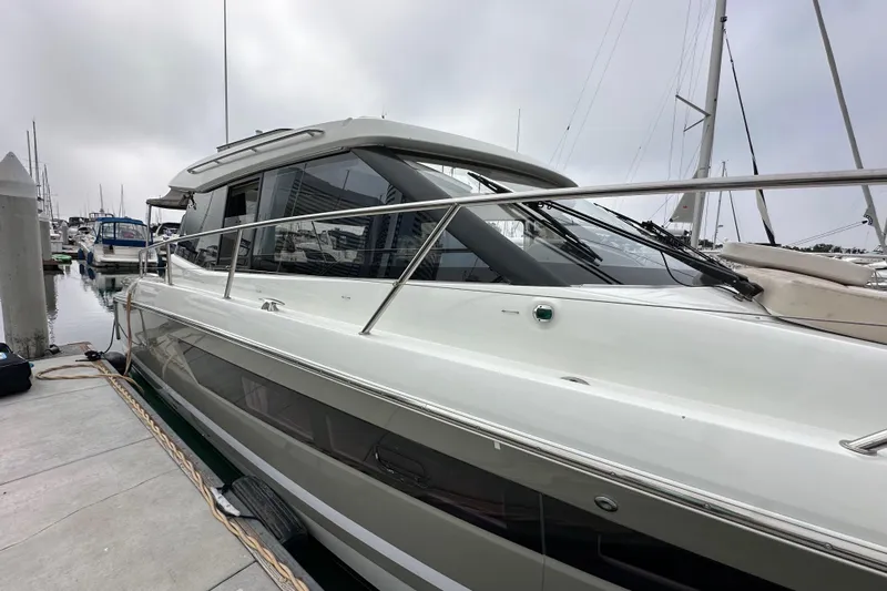  Yacht Photos Pics 2015 Jeanneau NC11 yacht docked at marina, showcasing sleek design and modern features.