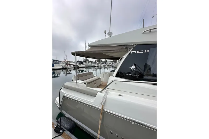  Yacht Photos Pics 2015 Jeanneau NC11 yacht docked at marina, showcasing sleek design and modern features.