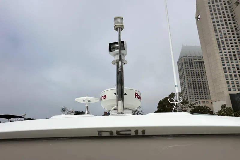  Yacht Photos Pics 2015 Jeanneau NC11 boat with radar equipment, cityscape background.