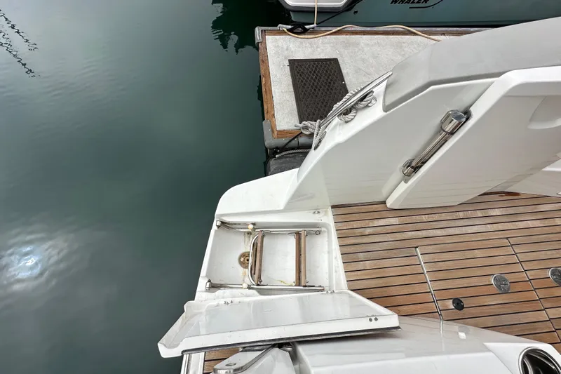  Yacht Photos Pics 2015 Jeanneau NC11 yacht stern with teak deck and swim platform ladder.