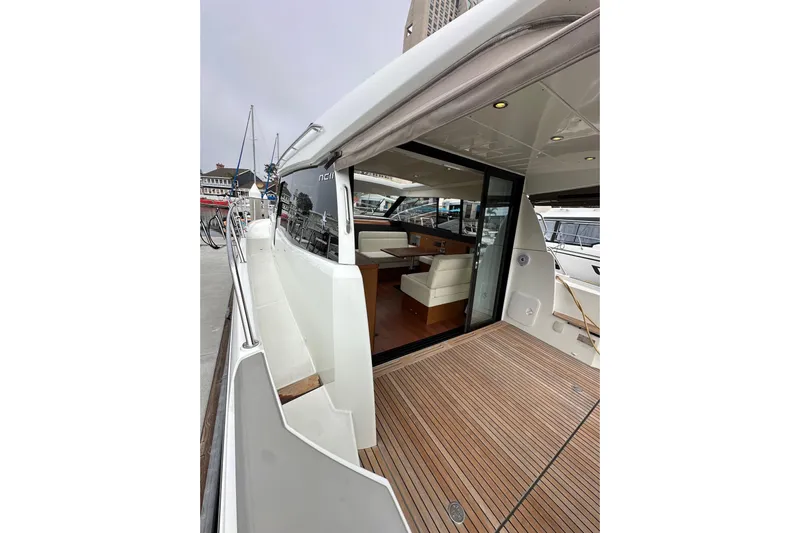  Yacht Photos Pics 2015 Jeanneau NC11 yacht with open deck and modern interior at dock.