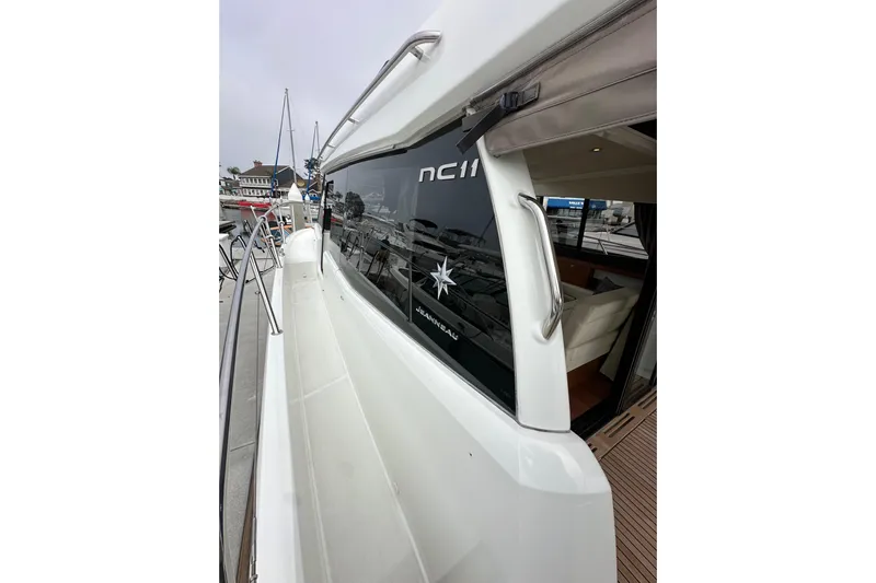  Yacht Photos Pics 2015 Jeanneau NC11 yacht docked, showcasing sleek design and modern features.