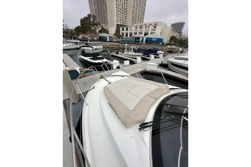  Yacht Photos Pics 2015 Jeanneau NC11 yacht docked in a marina with cityscape background.