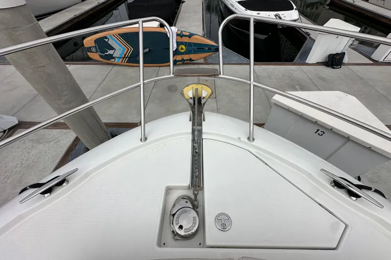  Yacht Photos Pics Bow view of 2015 Jeanneau NC11 yacht docked with paddleboard.