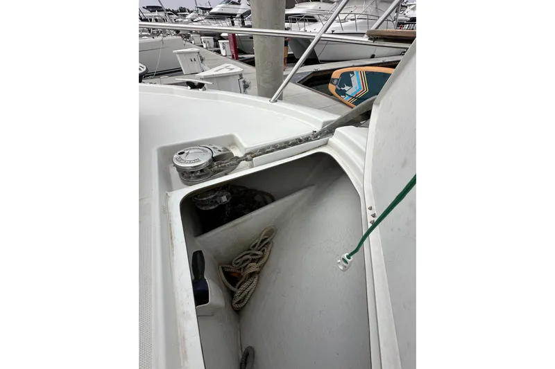  Yacht Photos Pics Anchor compartment of 2015 Jeanneau NC11 boat with ropes and equipment.