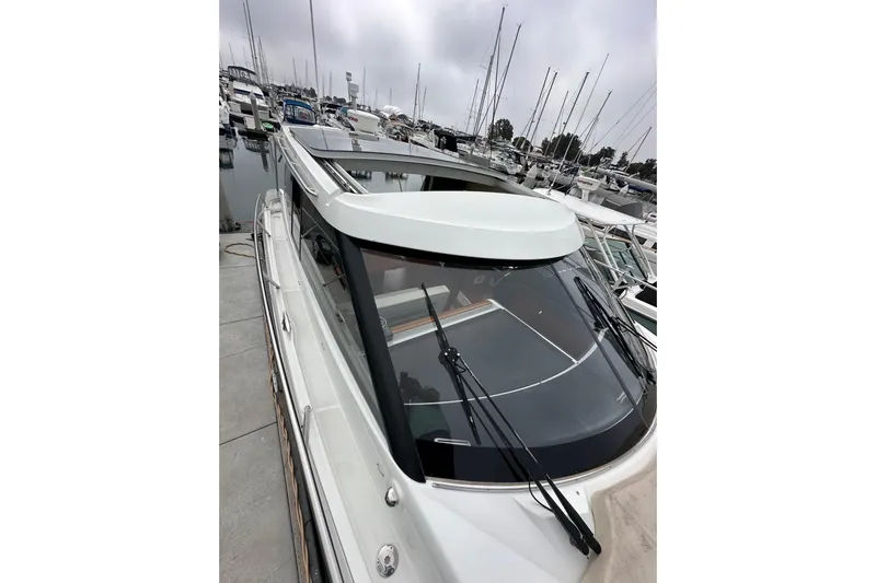  Yacht Photos Pics 2015 Jeanneau NC11 yacht docked in a marina, showcasing sleek design and modern features.