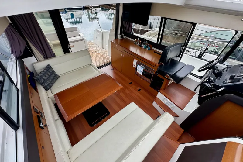 Yacht Photos Pics Interior of 2015 Jeanneau NC11 yacht with elegant seating and helm station.