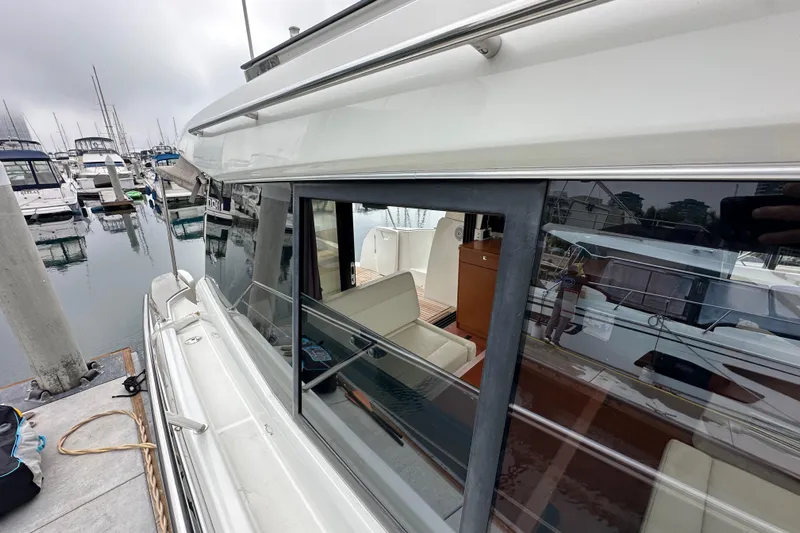  Yacht Photos Pics 2015 Jeanneau NC11 yacht docked at marina, showcasing sleek design and spacious interior.