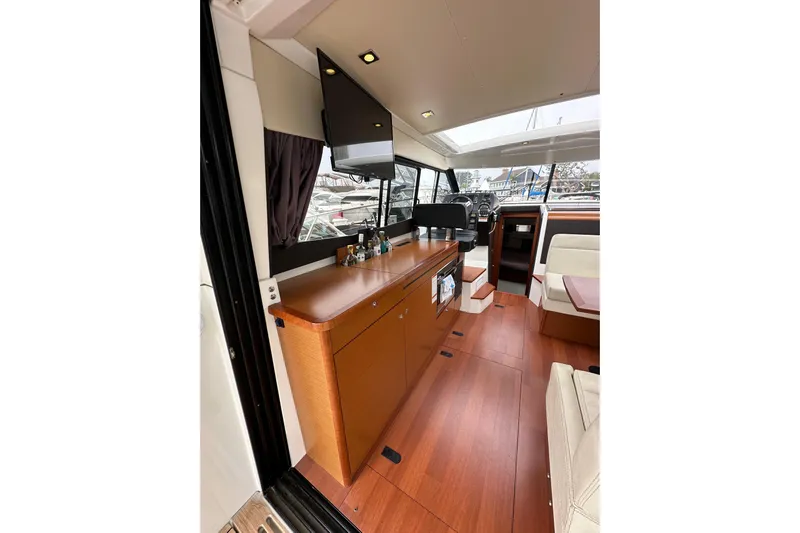  Yacht Photos Pics 2015 Jeanneau NC11 interior with modern wood finish and spacious layout.