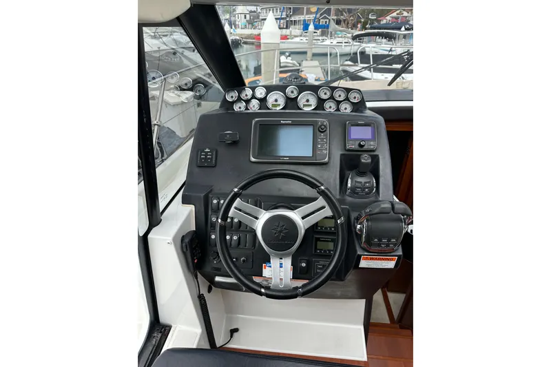  Yacht Photos Pics 2015 Jeanneau NC11 helm with modern navigation instruments and steering wheel.